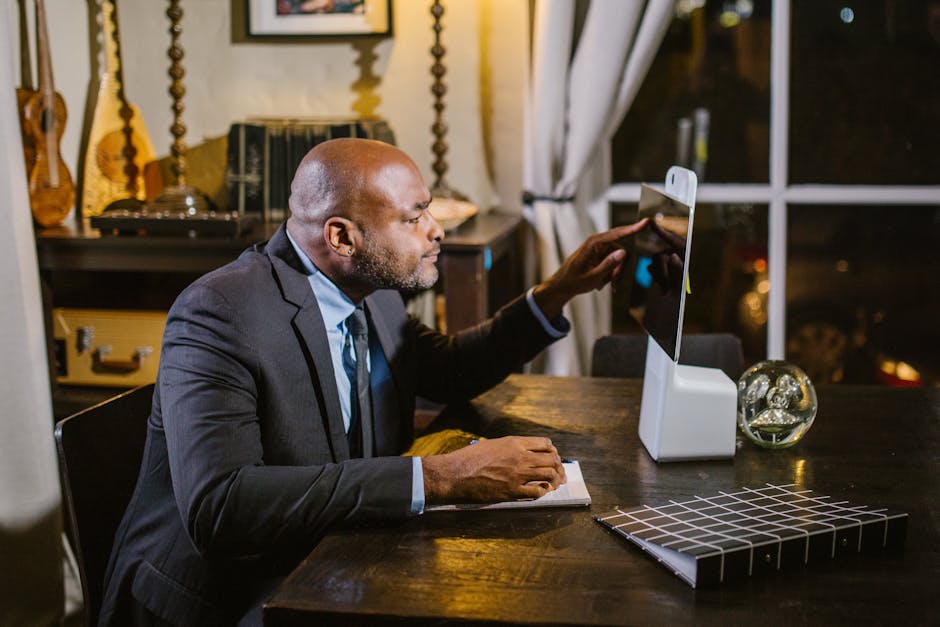 Businessman using a computer at home office during the evening